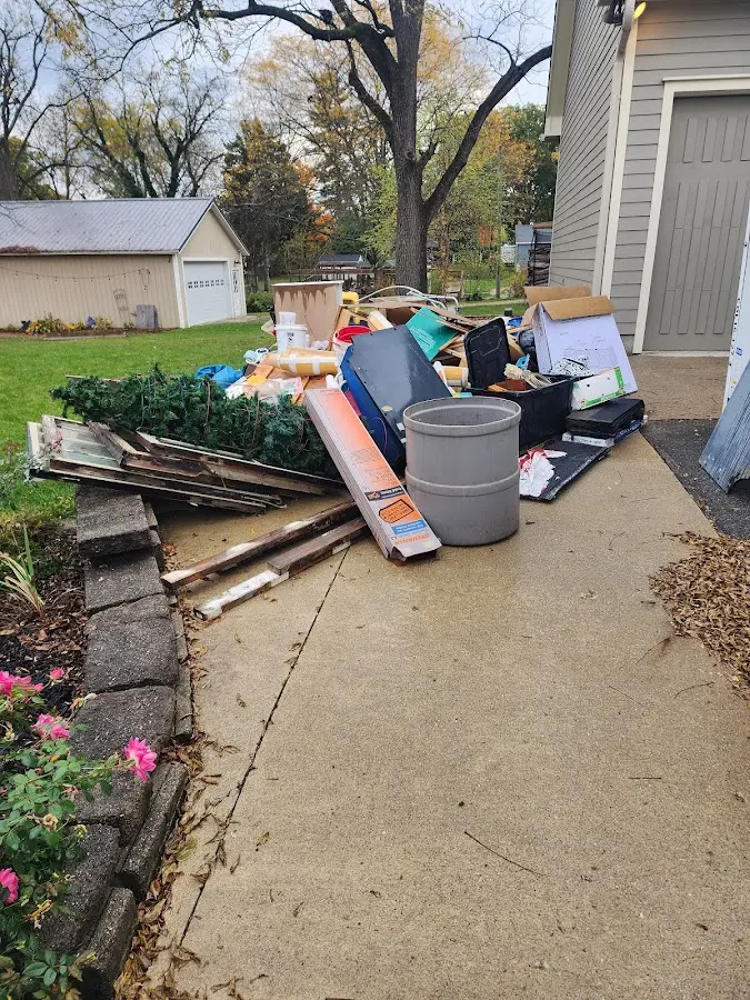 Dumpster being loaded with debris for Estate Cleanout Dumpster Rental in Twin Lakes